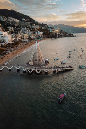 Photo for Vertical view of Los Muertos Beach Pier Puerto Vallarta Mexico in January looking south during lovely sunset. - Royalty Free Image