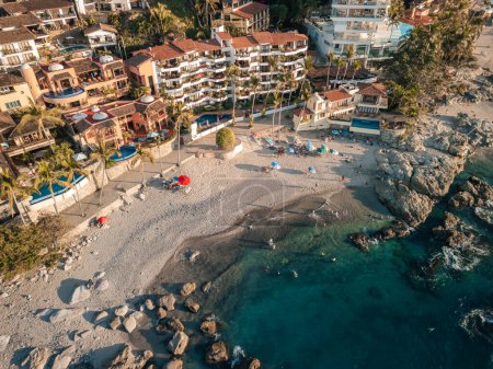 Top down aerial view of Conchas Chinas Beach in Puerto Vallarta Mexico showing rocks, sand, beauty.