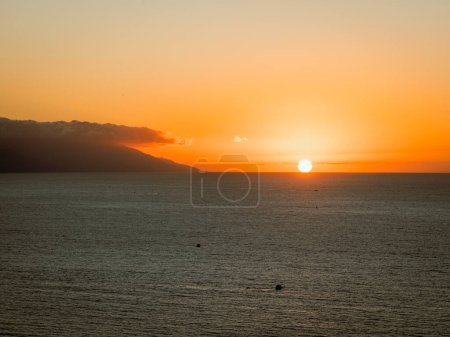 Sun setting over Banderas Bay seen from mirador at Hill of the Cross Viewpoint in Puerto Vallarta, Mexico .