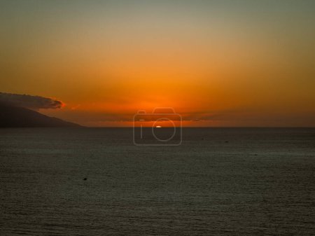 Sun setting over Banderas Bay seen from mirador at Hill of the Cross Viewpoint in Puerto Vallarta, Mexico .