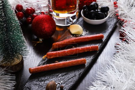 Photo for Smoked oblong-shaped sausages as an appetizer for beer on the New Year's table. Close-up - Royalty Free Image