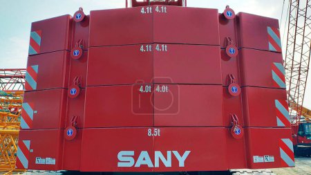 Photo for Jakarta, Indonesia - August 11, 2022: Photo of red painted Sany counterweight crawler crane installed at the back of the crane. - Royalty Free Image