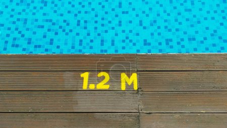 Téléchargez les photos : Deck of swimming pool edge 1.2 meter deep sign. - en image libre de droit