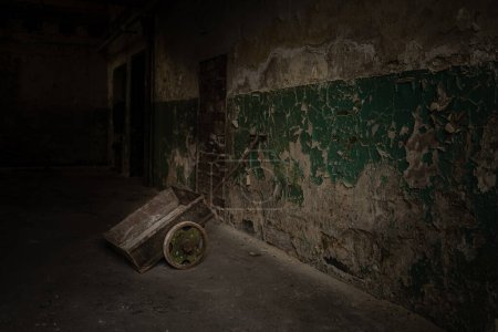 Foto de Un viejo carro de madera en un almacén de zapatos con una pared verde rayada - Imagen libre de derechos