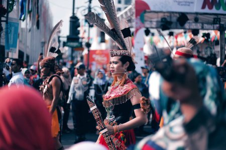 Photo for A woman in traditional clothes in the middle of a crowd at a carnival event - Royalty Free Image
