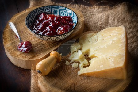 Photo for Hard cheese with bowl of berry jam on the table - Royalty Free Image