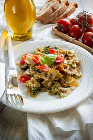 Photo for Dish of wholemeal pasta with Genoese pesto and cherry tomatoes - Royalty Free Image