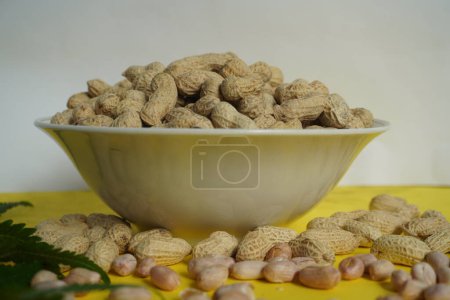 Photo for Peanuts. A bowl of roasted Peanuts is ready to be consumed. These foods contain the minerals Calcium and Phospor which are quite high. - Royalty Free Image