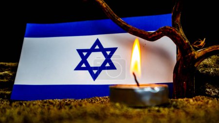Photo for Israeli flag and burning candles in front of it, Holocaust memory day - Royalty Free Image