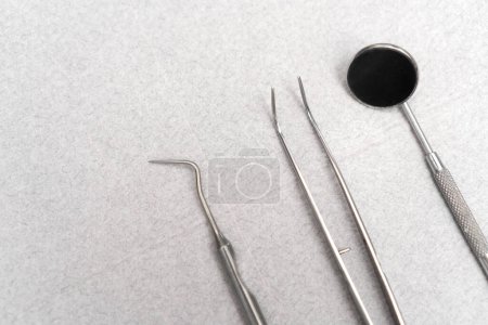 Close-up of dental instruments on a table on a white paper napkin