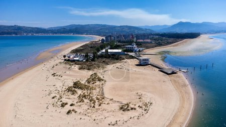 Aerial view of the sandy dune of Laredo, La Salve and Regaton beaches, the Cantabrian Sea, the Treto river, the city, and the surrounding mountains. Laredo, Cantabria, Spain.
