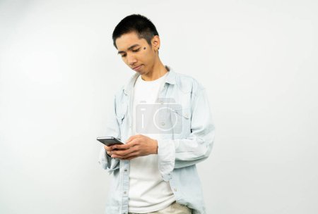 Téléchargez les photos : Jeune homme asiatique jouant jeu mobile. asiatique jeune homme regardant smartphone - en image libre de droit