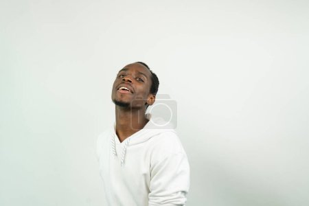 Photo for Portrait of a young african american man against white background - Royalty Free Image