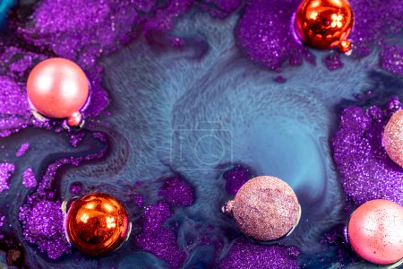 Photo for Christmas decorations on abstract color mixing of acrylic for use as background. Acrylic texture with marble pattern, purple marbling background - Royalty Free Image