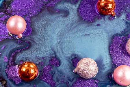Photo for Christmas decorations on abstract color mixing of acrylic for use as background. Acrylic texture with marble pattern, purple marbling background - Royalty Free Image