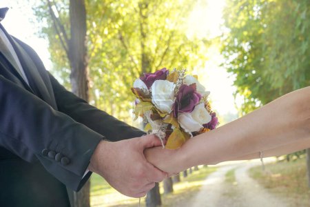 Photo for Bride and groom holding bridal bouquet - Royalty Free Image