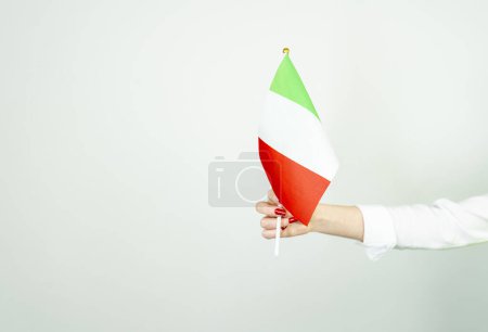 Photo for Woman's hand holding the flag of italy - Royalty Free Image