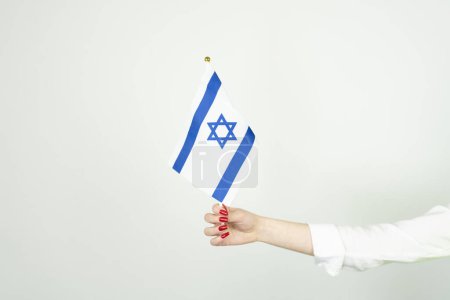 Foto de Mano de mujer sosteniendo la bandera de Israel - Imagen libre de derechos