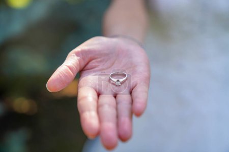 Photo for Bride holding a wedding ring - Royalty Free Image