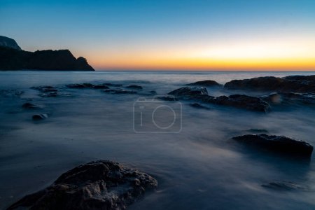 Photo for Ocean waves crash at a Pacific Ocean sunset - Royalty Free Image
