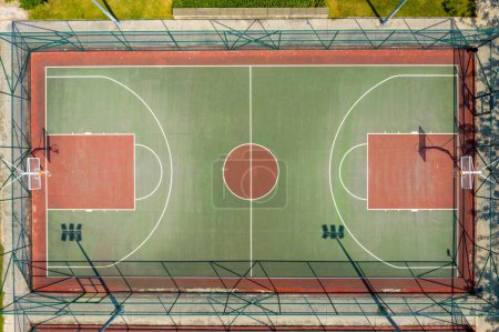 aerial drone view of empty red basketball sports field 