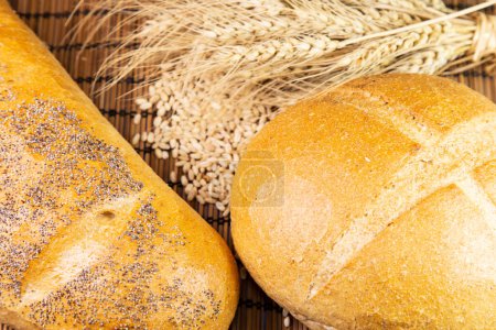 Photo for Bread and wheat ears  on wooden background - Royalty Free Image