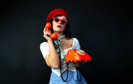 Photo for Young Woman Talking on Orange Retro Phone. Vintage Girl Talking Pin Up Phone - Royalty Free Image
