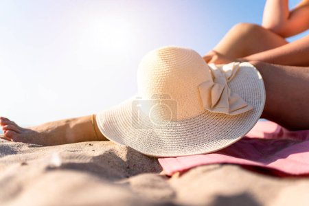 Photo for Beautiful young woman sunbathing on the beach, enjoying the sun and holiday - Royalty Free Image