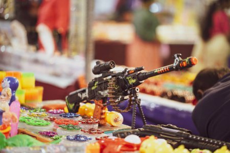 Photo for A toy machine gun for kids, children toy gun selling on market, mall, fair, store - Royalty Free Image