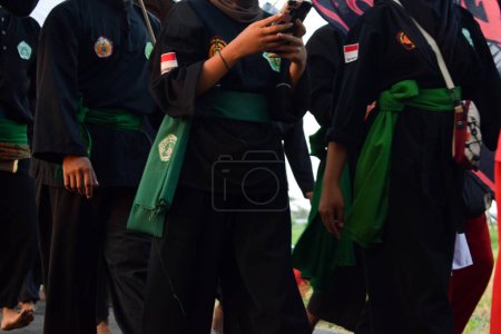 Photo for Teenagers wearing pencak silat or martial arts from indonesia uniform, celebration of indonesia independence day 17 agust. - Royalty Free Image