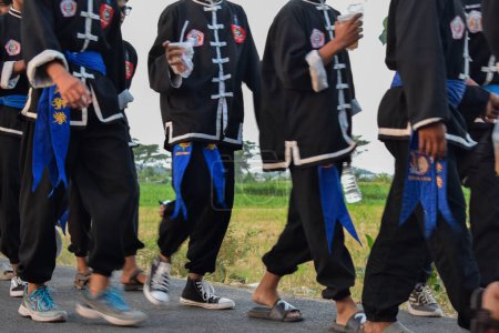 Photo for Tuban Indonesia August 29, 2023, Teenagers wearing pencak silat custome in commemoration of the 78th Anniversary of the Republic of Indonesia at Dasin Village Tambakboyo district. - Royalty Free Image