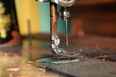 Photo for Close up sewing machine with needle on wood table, antique sewing machine with dust - Royalty Free Image