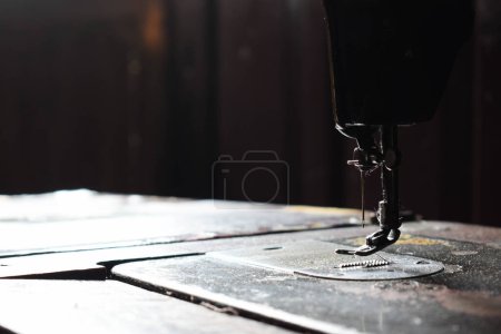 Téléchargez les photos : Gros plan machine à coudre avec aiguille sur table en bois, machine à coudre antique avec poussière - en image libre de droit