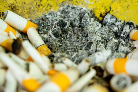 Photo for Top view ashtray glass and cigarette ash pile close up - Royalty Free Image