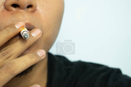 Téléchargez les photos : Fermer un homme fumant avec une cigarette faite à la main - en image libre de droit