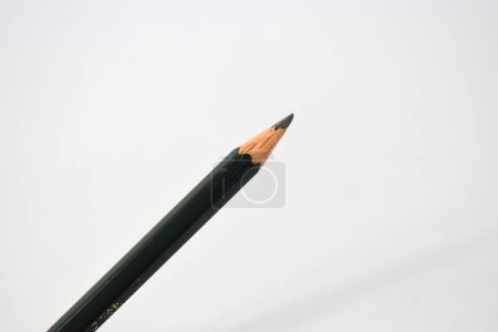 Photo for Green pencil sharpener and dark green pencils, pencil shavings on white background - Royalty Free Image