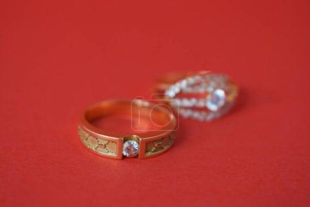Téléchargez les photos : Fermer Bague dorée avec diamant sur fond rouge isolé - en image libre de droit