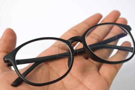 Photo for Hand hold Black frame eyeglasses unisex isolated on white background - Royalty Free Image