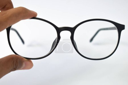 Photo for Hand hold Black frame eyeglasses unisex isolated on white background - Royalty Free Image