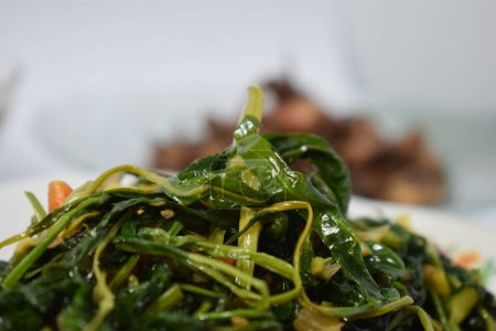 Photo for Close up stir fried spinach on white plate isolated white background - Royalty Free Image