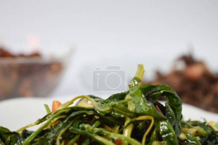 Photo for Close up stir fried spinach on white plate isolated white background - Royalty Free Image
