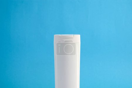 Téléchargez les photos : Bouteille blanche shampooing blanc pour maquette avec fond bleu, beauté soins de santé bouteille maquette. - en image libre de droit