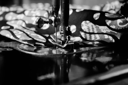 Photo for Vintage Black and White Close up Senior Female Tailor Sewing batik indonesian fabric into cloth, elder senior and vintage black and white concept - Royalty Free Image