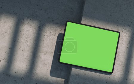 Photo for Mockup of black tablet device, lay on a concrete surface, outdoor. Clipping path for display included. 3D rendering - Royalty Free Image