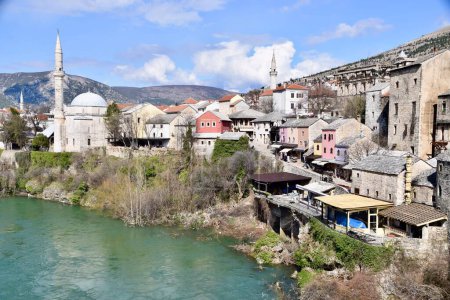 Photo for Mostar, Bosnia and Herzegovina. March 2020. Colourful buildings, street scene, shops and restaurants. On the River Neretva. - Royalty Free Image