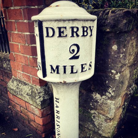Photo for Derby, UK, July 2 , 2020. Vintage Road Milage sign, Derby 2 Miles. Derby, England - Royalty Free Image