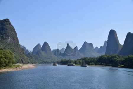 Photo for Pleasure Boats on The Li River in The Karst Mountains. Guilin, Guangxi, China. October 30, 2018. - Royalty Free Image