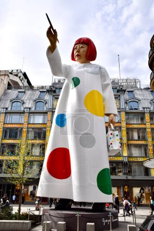 Photo for Giant Statue of Yayoi Kusama, on rue du Pont Neuf, between the headquarters of Louis Vuitton and the Samaritaine.Paris France. March 29, 2023. - Royalty Free Image