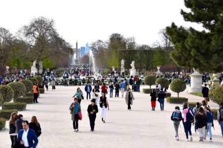 Photo for People walking through The Jardin des Tuileries, with Place de la Concorde and Arc de Triomphe in the distance. Paris, France. March 29, 2023. - Royalty Free Image