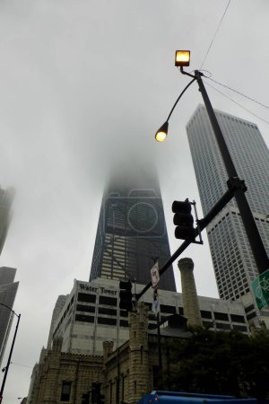 Photo for The Hancock Tower, (now 875 North Michigan Avenue) ,disappearing into a misty sky.  Chicago, IL, USA. September 22, 2016. - Royalty Free Image